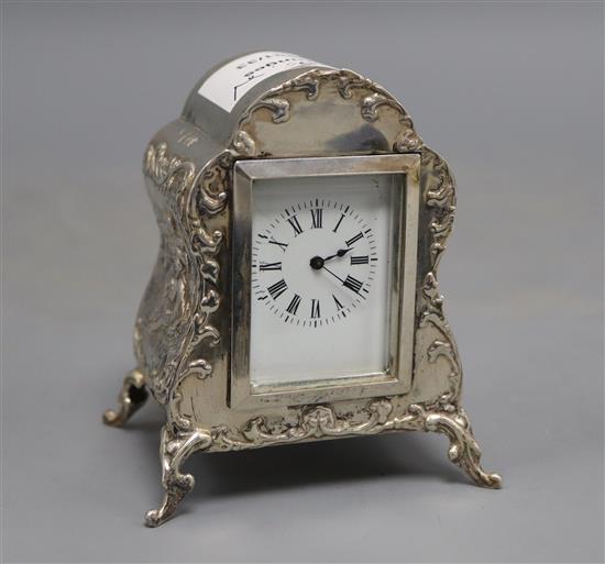 A late Victorian repousse silver mounted timepiece, by William Comyns, London, 1900, 9.5cm, with key.